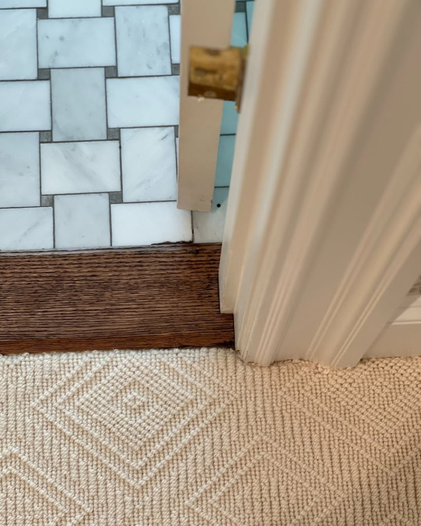 Detailed view of finished flooring and door trim installed by Kevin Cradock Builders in Boston, MA.