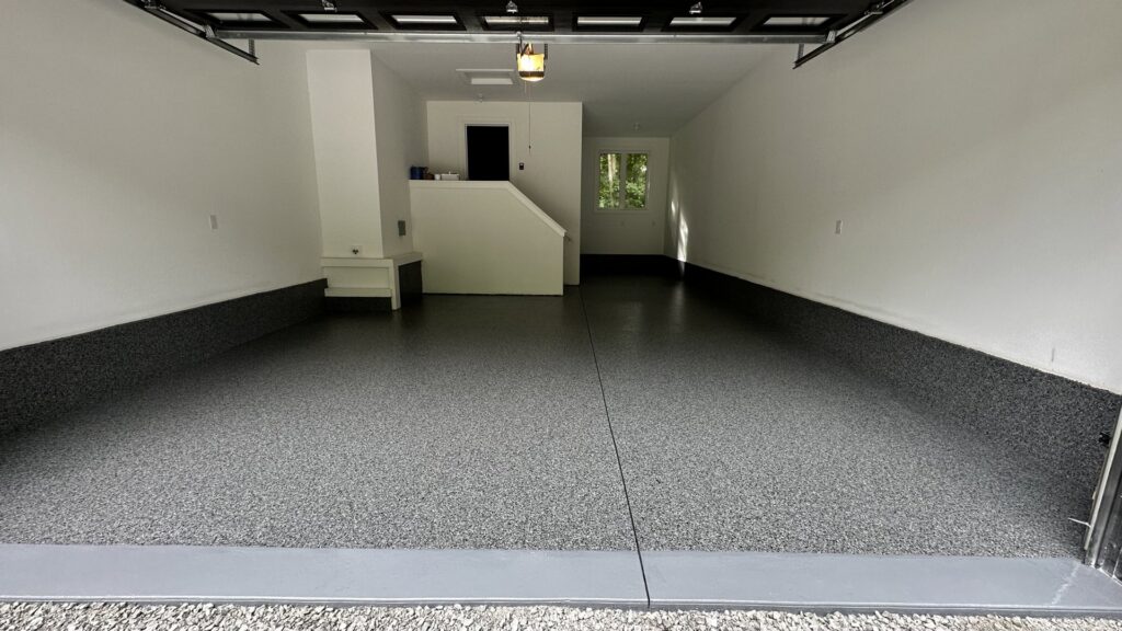 A newly finished garage with a gray epoxy flake floor by Dappa Epoxy Flooring Contractor in Tampa, FL.