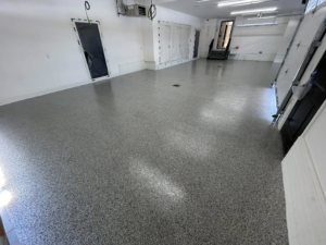A newly installed grey speckled epoxy floor in a garage by DuraFloor Epoxy Pros, providing durable flooring in Akron, OH.