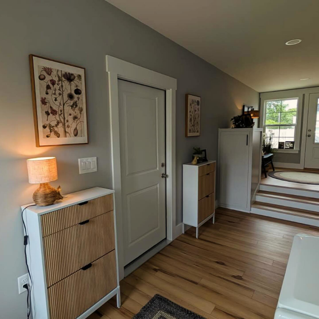 A beautifully finished hallway and entryway renovation with new flooring and custom cabinets by Seaside Craftworks LLC in Wilmington, NC.