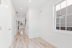 A finished hallway with new tile flooring and white walls, part of a renovation by EK Construction, LLC in Philadelphia, PA