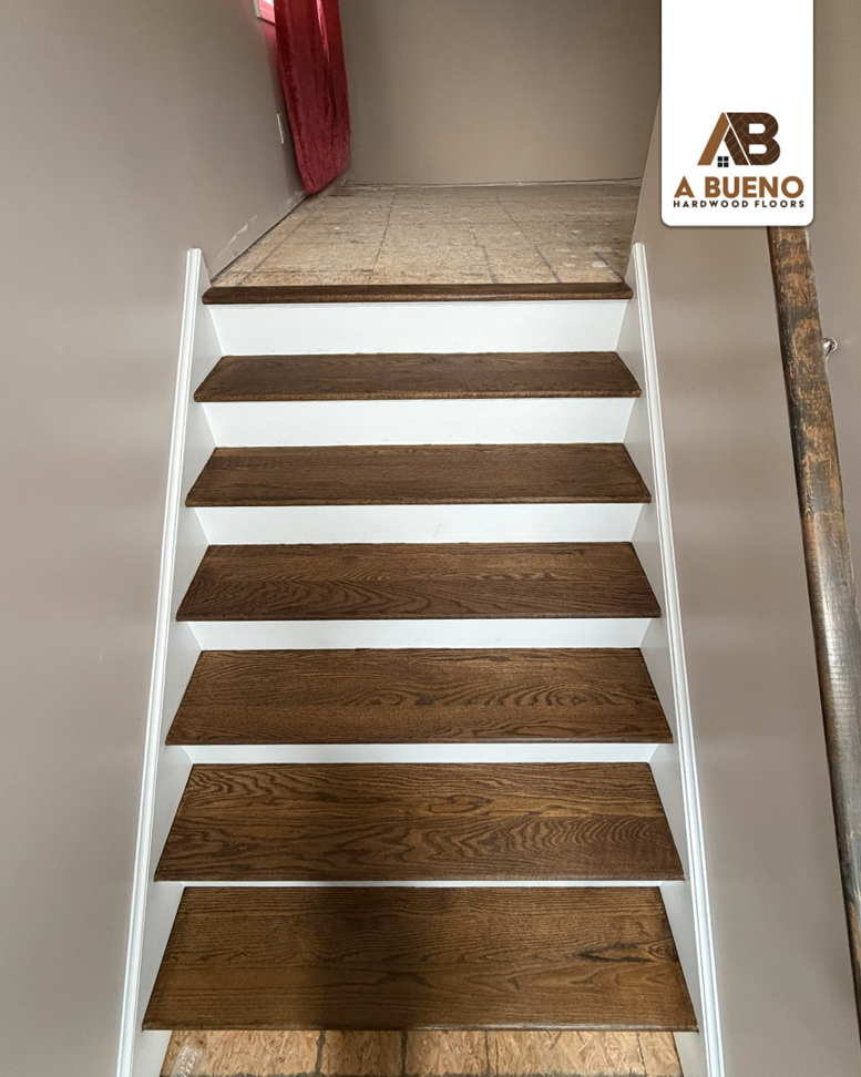Newly stained dark hardwood stair treads completed by Bueno Hardwood Floors in Fairfield, CT