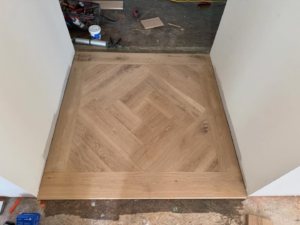 A beautifully finished section of herringbone hardwood flooring by Heritage Floors of Hanover LLC in Mechanicsville, VA.