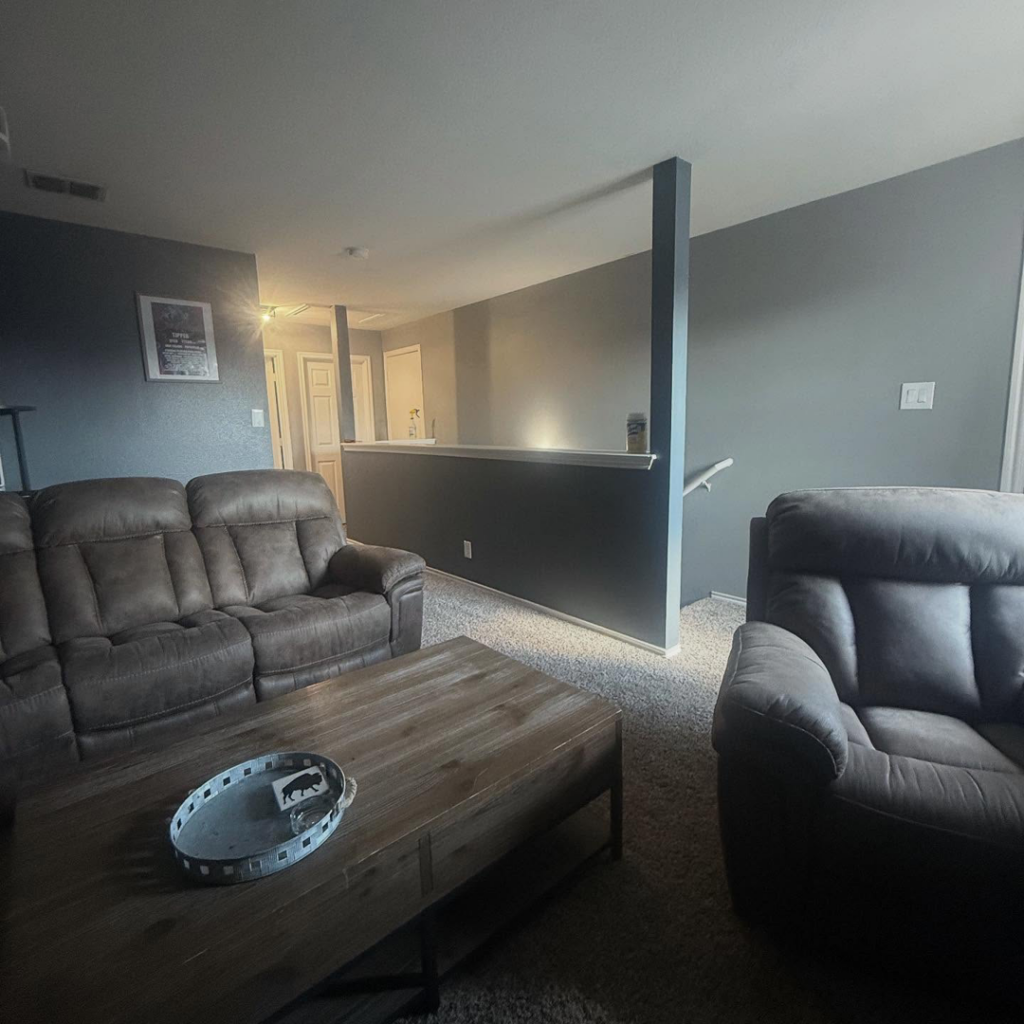 A finished interior living room painting project with grey walls by The First Choice Painting in San Antonio, TX