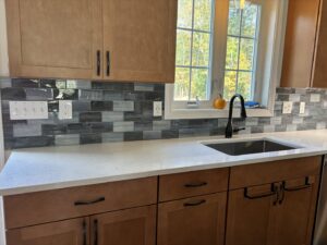A newly installed kitchen backsplash and countertop, showcasing kitchen renovation by Granite State Handyman & Home Repair in Derry, NH.