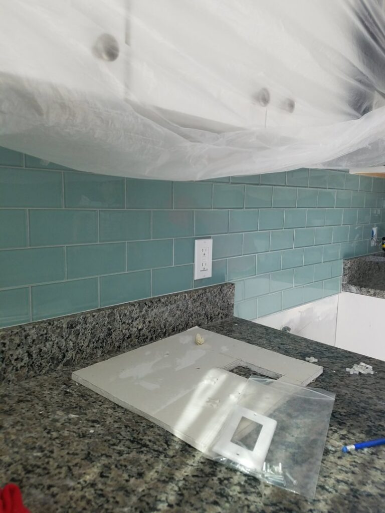 A newly finished light blue subway tile kitchen backsplash by JMQ Contractor INC in Philadelphia, PA
