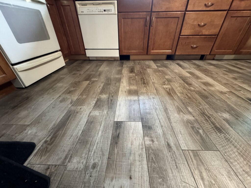 Newly installed finished kitchen flooring by Hawk Handyman Services in West Fargo, ND