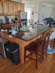 A completed kitchen renovation featuring dark granite countertops by Affordable Granite of KC in Kansas City, MO.
