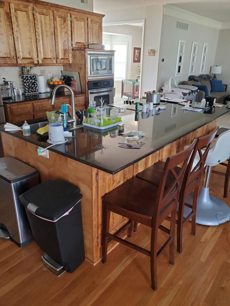 A completed kitchen renovation featuring dark granite countertops by Affordable Granite of KC in Kansas City, MO.