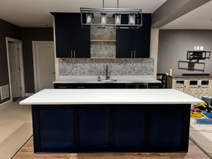 Finished kitchen island with white countertop and herringbone backsplash by GD Home Remodeling in Annadale, VA.