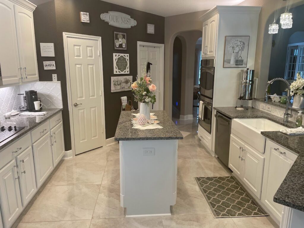A beautifully finished kitchen remodel with white cabinets and granite countertops by SRP construction in Houston, TX