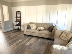 A beautifully finished living room featuring new board and batten walls and plank flooring by Amazing Handyman in Peoria, IL.
