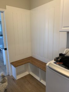Completed mudroom built-in bench with storage by Segovia LLC interiors, offering custom carpentry in Madison, WI.