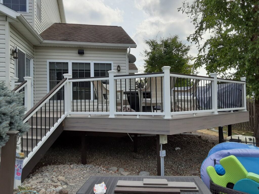 Newly constructed outdoor deck with railings and furniture by NS Construction in Imperial, CA.