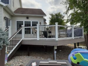 Newly constructed outdoor deck with railings and furniture by NS Construction in Imperial, CA.