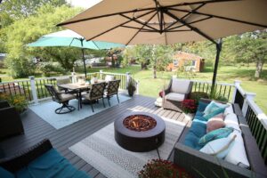 A beautifully finished outdoor deck with comfortable furniture and a fire pit by Inspired Renovation & Hardscape's in Lorain, OH.