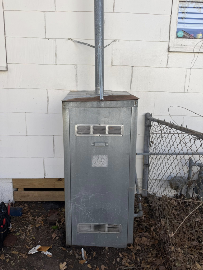A fully enclosed outdoor water heater unit after installation or repair by High Tide Home Remodeling in Charleston, SC.