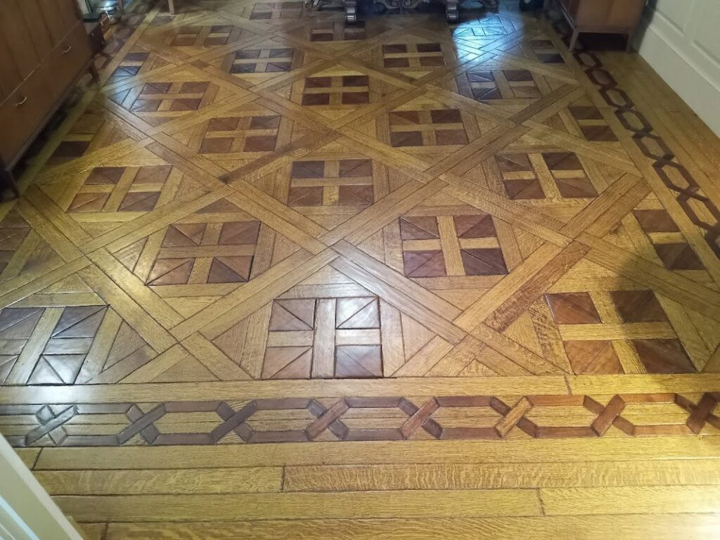 A beautifully finished intricate parquet wood floor installed by Robert C. Mihaich Wood Flooring in Worcester, MA.