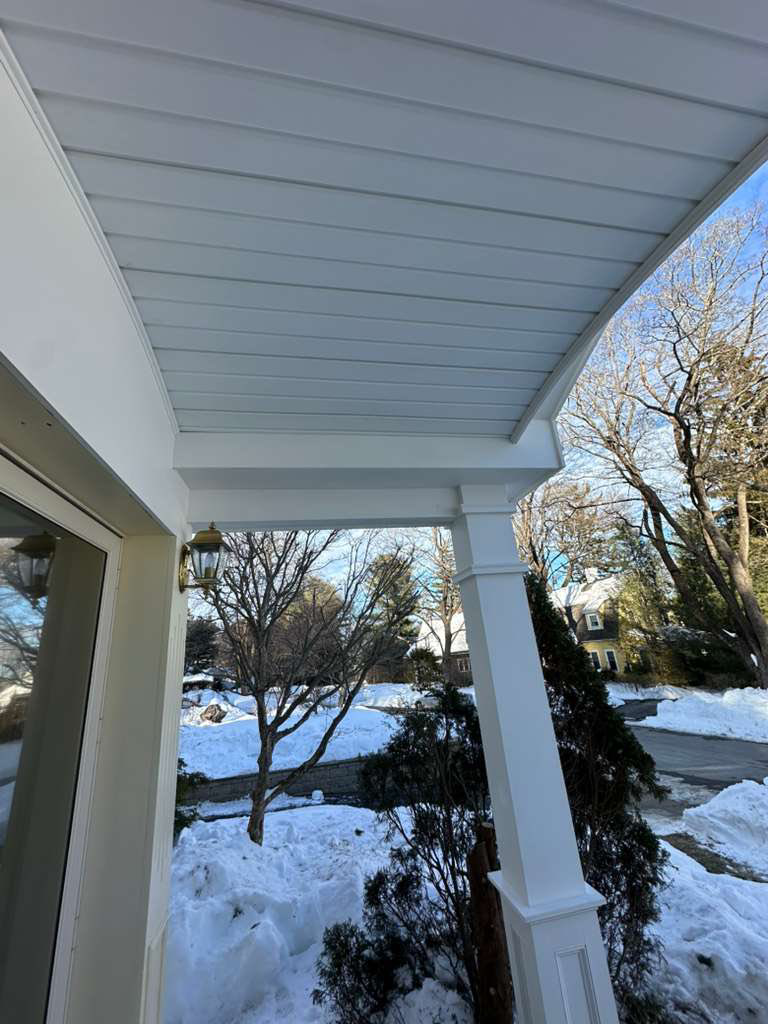 A detailed view of a newly finished porch ceiling and a white support column, part of a home improvement project by Remodel or Renew Home Improvement in Worcester, MA.