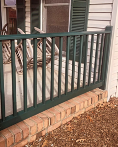 A section of a porch railing after painting, completed by DEMIA 17 & Company LLC in Waldorf, MD.