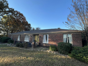 A residential house with a newly finished roof project, showcasing quality work by Skyline Roofing L.L.C in Jackson, TN.
