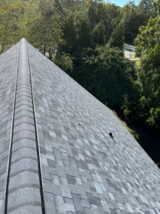 A close-up view of a finished roof ridge with a vent, installed by New American General Construction INC in Richmond, VA.