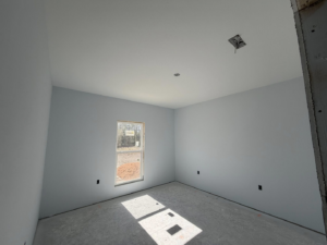 A finished room featuring light blue painted walls and expert drywall installation by JM Drywall LLC in Dothan, AL.