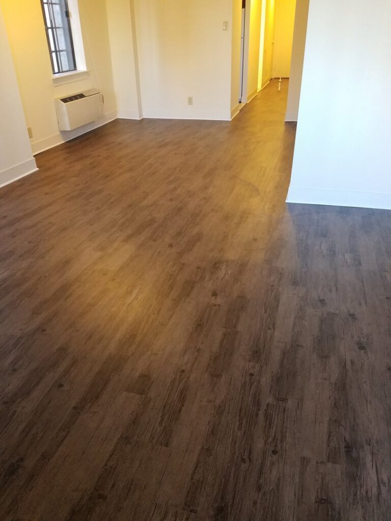 A finished room with newly installed wood-look flooring by JMQ Contractor INC in Philadelphia, PA