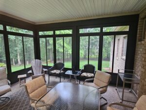 A comfortable, finished screened porch interior with outdoor furniture by X-Terior Techs in Henrico, VA.