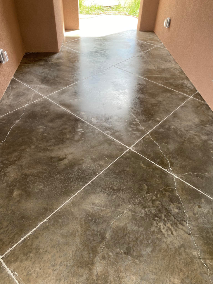 A beautifully finished and sealed concrete floor in a hallway, completed by Manning's Attention 2 Detail Painting, LLC in Tucson, AZ