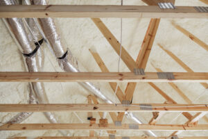 A close-up view of a wall with newly applied spray foam insulation by Absolute Pro Insulation in Corpus Christi, TX.
