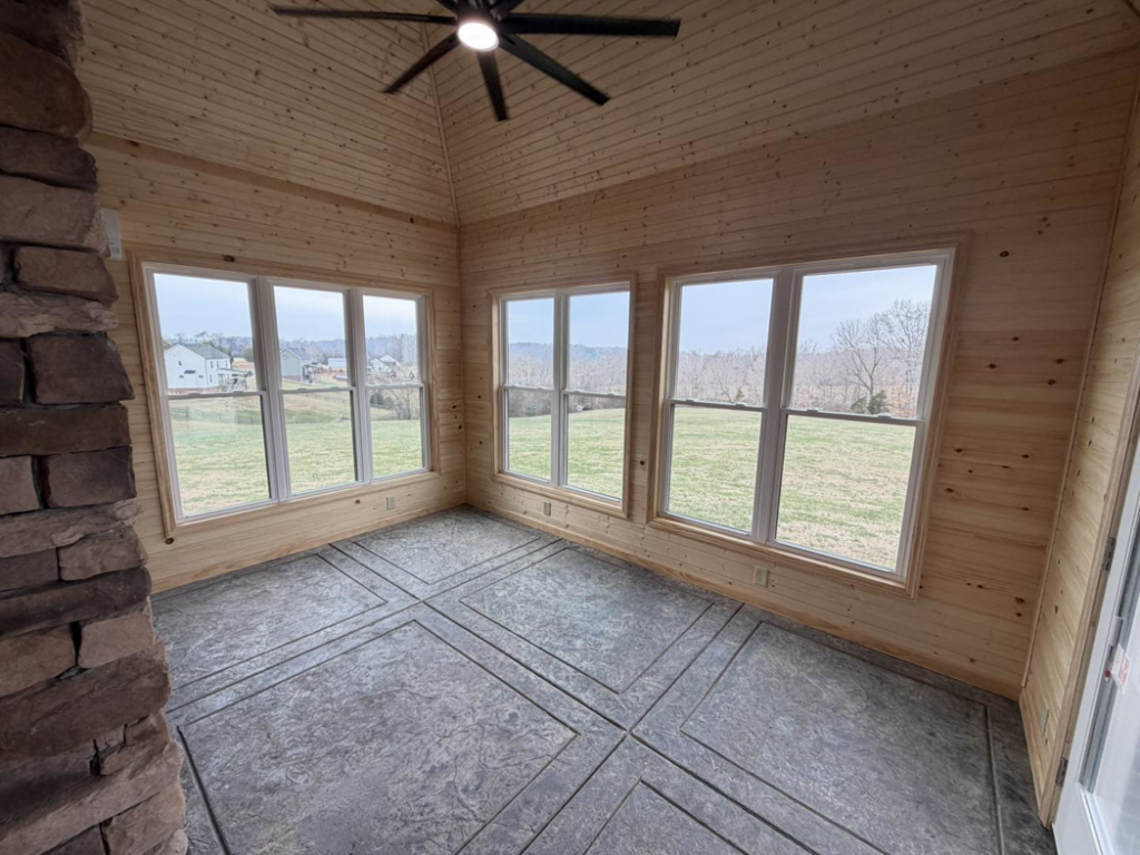 A finished sunroom addition with new windows, wood ceiling, and patterned floor by JM Home and Property Services in Clarksville, TN
