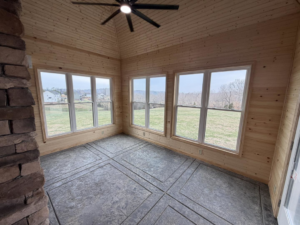 A finished sunroom addition with new windows, wood ceiling, and patterned floor by JM Home and Property Services in Clarksville, TN