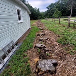 A neatly finished wood chip path next to a building, demonstrating the cleanup work by Green Mtn Stump Grinding in Montpelier, VT.