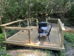 A newly finished wooden deck installation by S & H Painting and Drywall LLC, providing handyman services in Montgomery, AL.