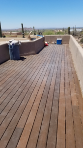 A newly installed or renovated wooden deck by Tier 1 Contracting Inc. in Apache Junction, AZ, overlooking a desert landscape.