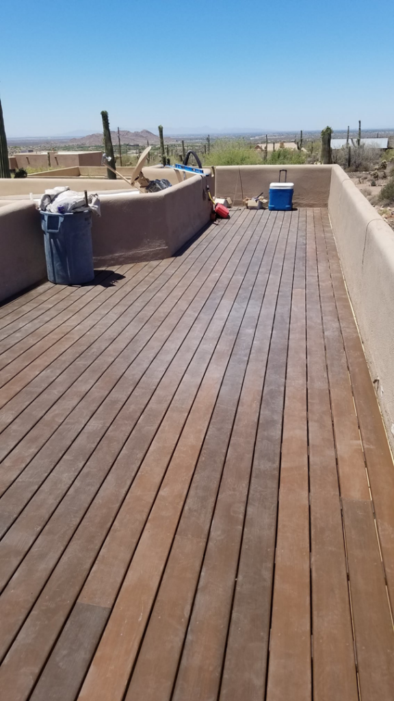 A newly installed or renovated wooden deck by Tier 1 Contracting Inc. in Apache Junction, AZ, overlooking a desert landscape.
