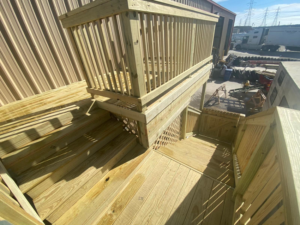 Finished wooden deck and stairs with railings by JP Construction in San Antonio, TX.
