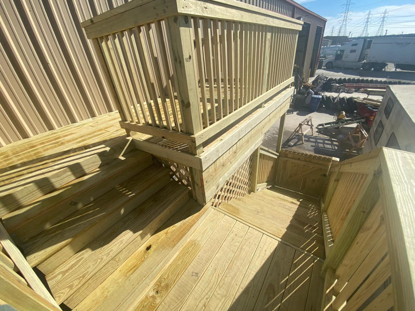 Finished wooden deck and stairs with railings by JP Construction in San Antonio, TX.