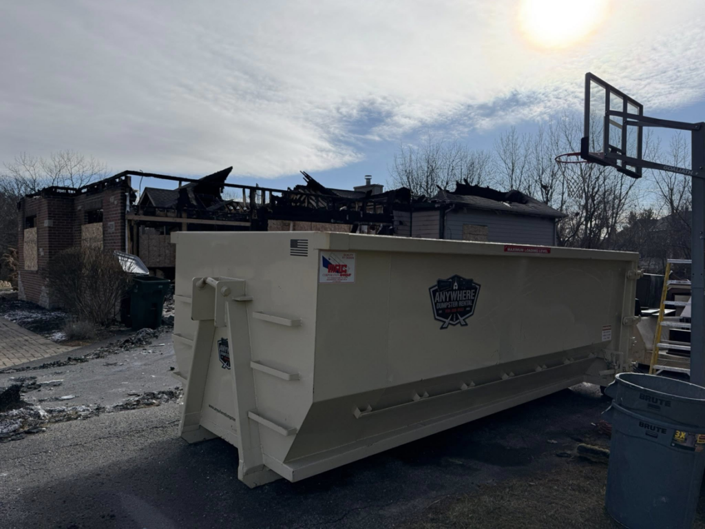 A large roll-off dumpster placed for fire damage debris removal by Anywhere Dumpster Rental in Bolingbrook Area, IL.