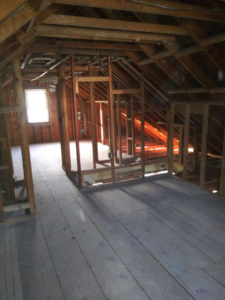 A fire-damaged and cluttered room requiring extensive cleanup and restoration by J-BO Enterprises, Inc in Wilmington, MA.