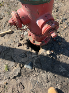 A red fire hydrant being installed or serviced by Absolute Fire Sprinklers in Bristol, CT.