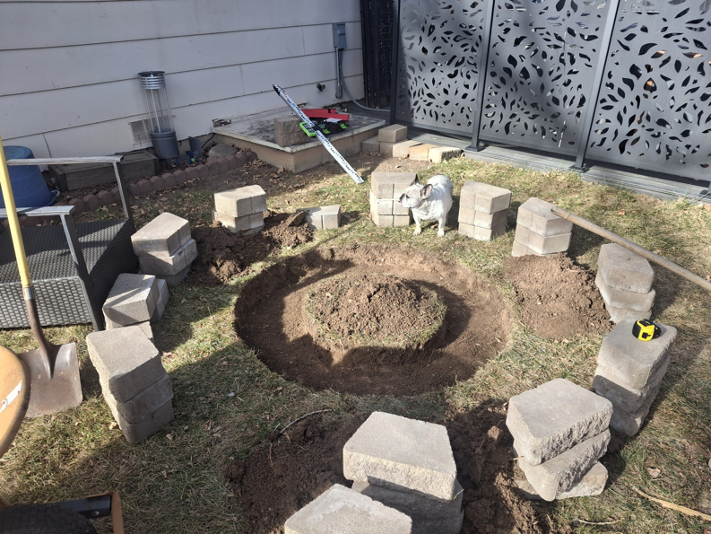 A circular area dug out for a fire pit or patio base, showing outdoor construction by Corebuilt Contracting LLC in Fort Collins, CO.