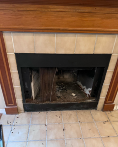 A fireplace undergoing demolition with the firebox removed and debris on the floor by PJC Solution Inc in Orlando, FL.