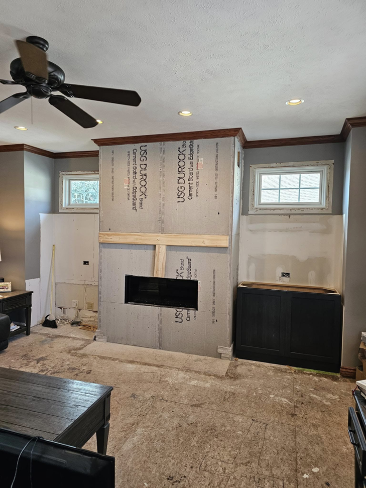 Handyman Dan INC working on fireplace framing and built-in cabinet installation in Fremont, NE.