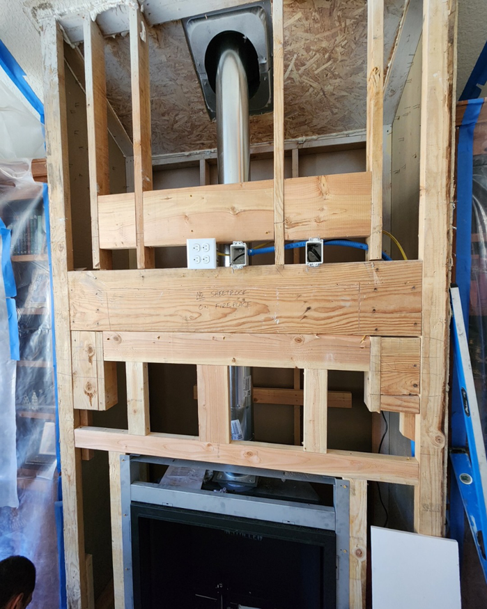 Internal framing and venting for a new fireplace installation, showing construction by Portland Fireplace and Chimney Inc. in Portland, OR.