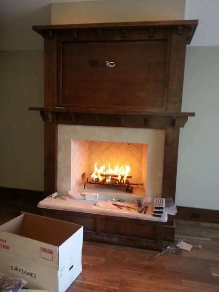 A fireplace installation in progress with tools and materials on the floor by Infinite Fire Features in Colorado Springs, CO.