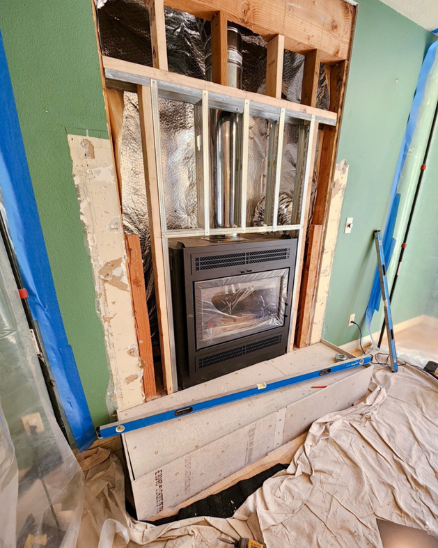 Fireplace installation in progress, showing framing, new insert, and hearth by Portland Fireplace and Chimney Inc. in Portland, OR.