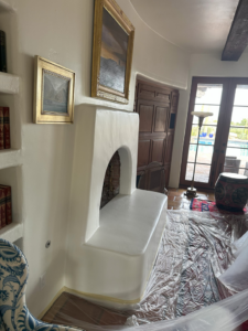 Fireplace area covered in plastic sheeting for painting preparation by Paint Co in Canyon Lake, CA