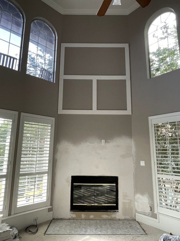 Fireplace renovation in progress, showing new mantel framing and wall preparation for tiling by Brewer Builds in Fort Worth, TX.